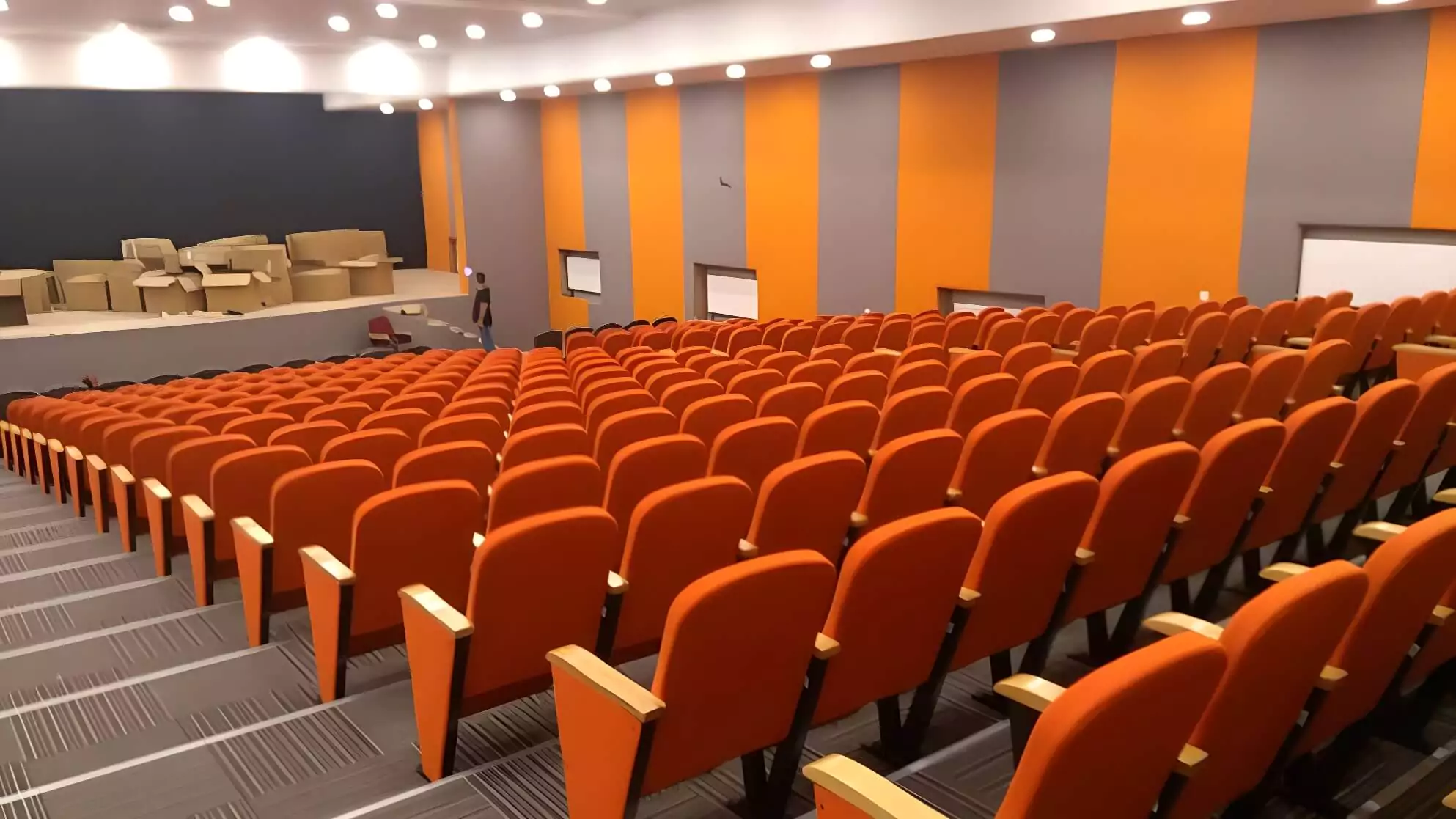 Our ergonomic conference chairs bring both support and elegance to this large corporate auditorium. Image